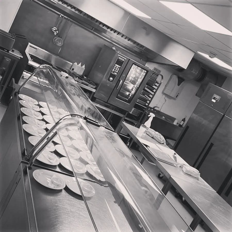The Feed My Crew kitchen with plates lined up along the service counter