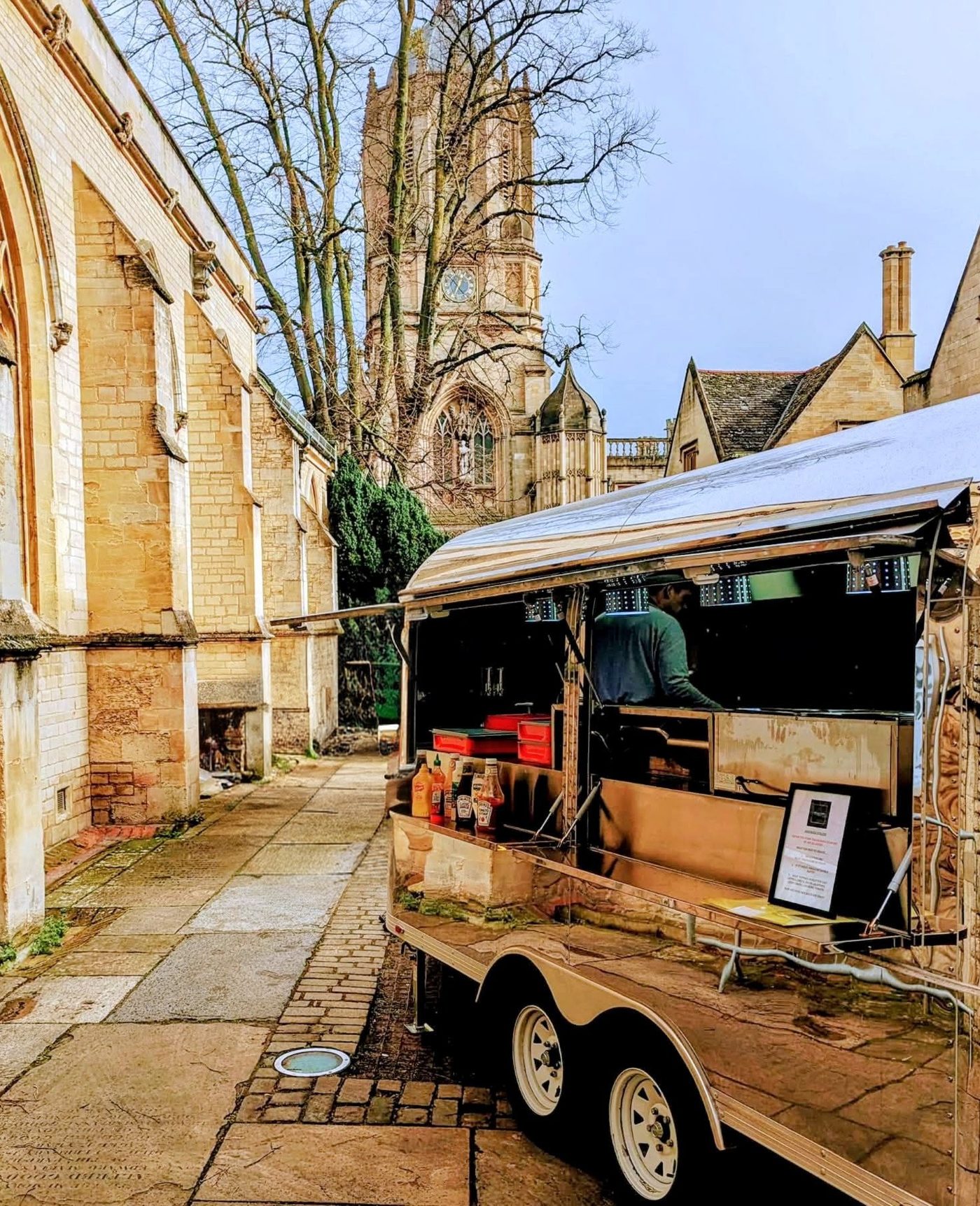 The Feed My Crew catering truck set up beside Oxford college buildings